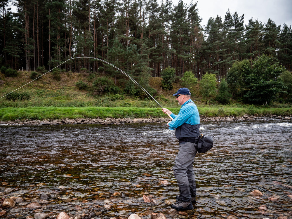 Angler playing an atlantic salmon river Dee, Scotland with Levaroa